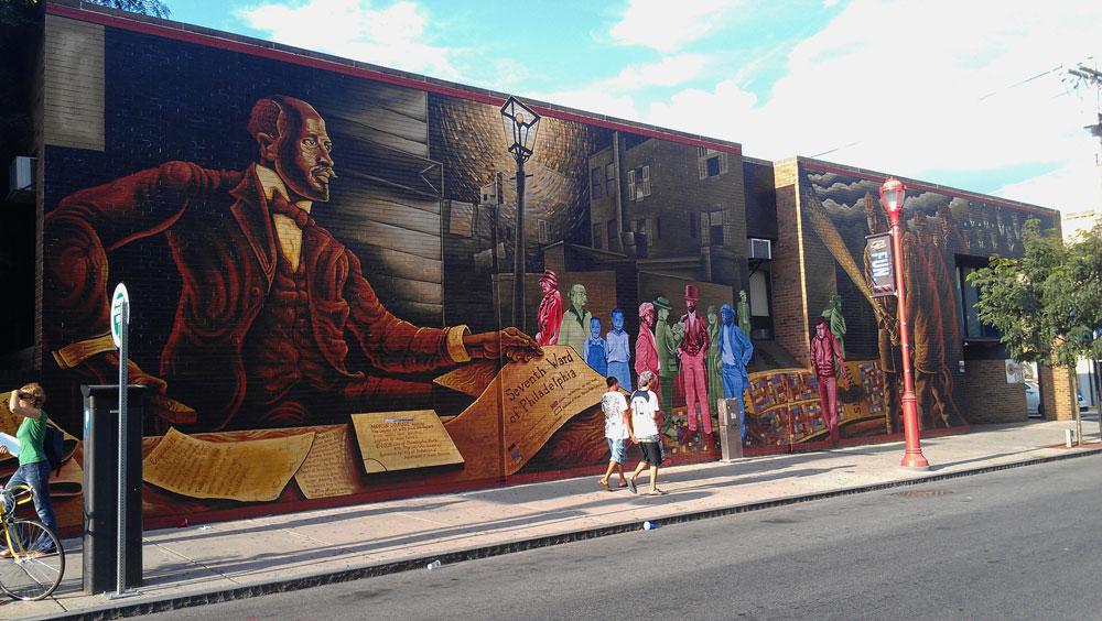 A view of the W.E.B. Du Bois–inspired wall mural, <em>Mapping Courage</em>, by Carl Willis Humphrey, at the corner of South St and S 6th St in Philadelphia / photo Ken Lum 