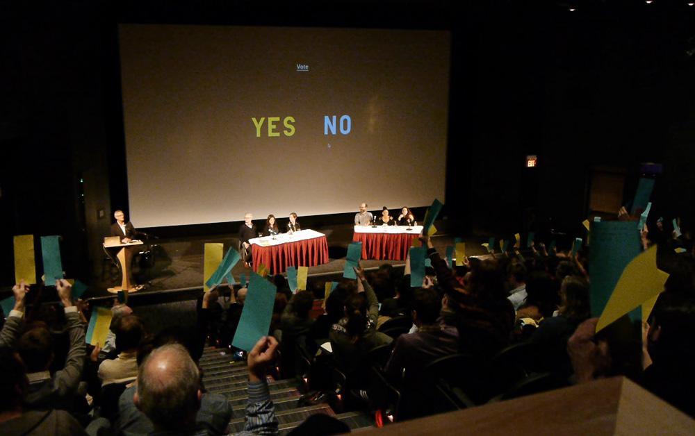 Audience members vote at the Institutions By Artists keynote debate “Should artists professionalize?,” October 13, 2012  