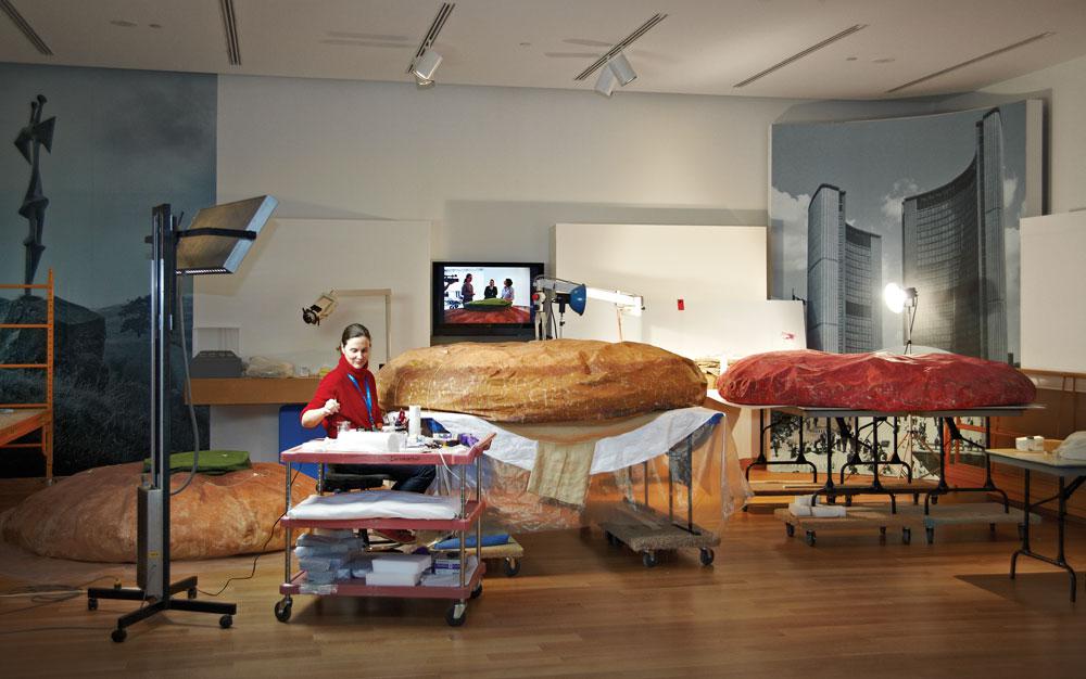 AGO conservator Sherry Phillips at work on Claes Oldenburg's <em>Floor Burger</em> / photo courtesy Art Gallery of Ontario