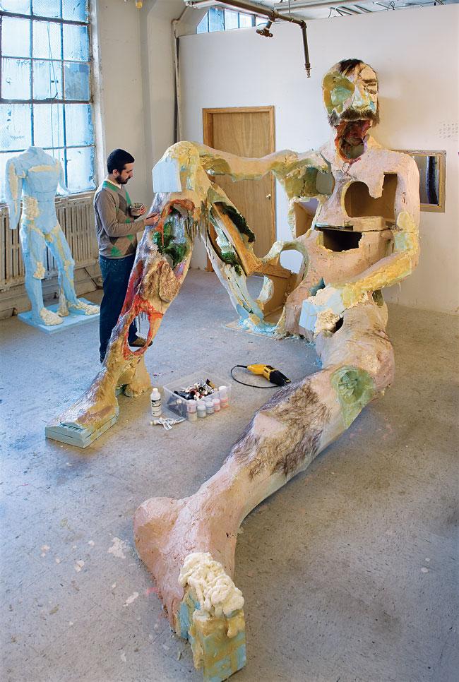 David Altmejd working on <em>The Giant 2</em> in 2007; the sculpture is constructed out of bronze, steel, taxidermied birds, quartz, feathers and other materials / photo by Ellen Page Wilson courtesy of Andrea Rosen Gallery, New York, and Stuart Shave/Modern Art, London