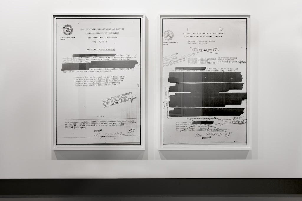 Installation view of panellist Dana Claxton's <em>AIM</em> works—blown-up photographs of redacted FBI documents related to the American Indian Movement—at Vancouver's Winsor Gallery