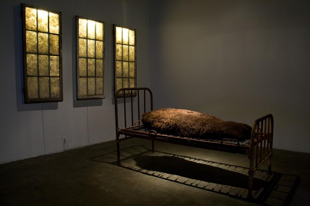 Adrian Stimson's <em>Sick and Tired</em>, part of “Witnesses” at the Belkin Art Gallery, includes windows and an infirmary bed from the Old Sun Residential School in Gleichen, Alberta. The artist and residential school survivor says he hopes using this material assists in exorcising some of the feelings around such experience, as well as in triggering public awareness.