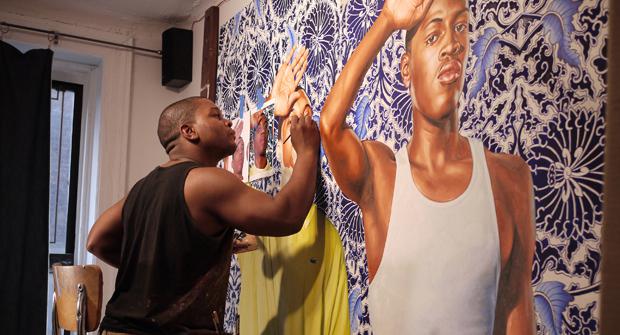 Lauded American artist Kehinde Wiley at work on one of his large portrait paintings.