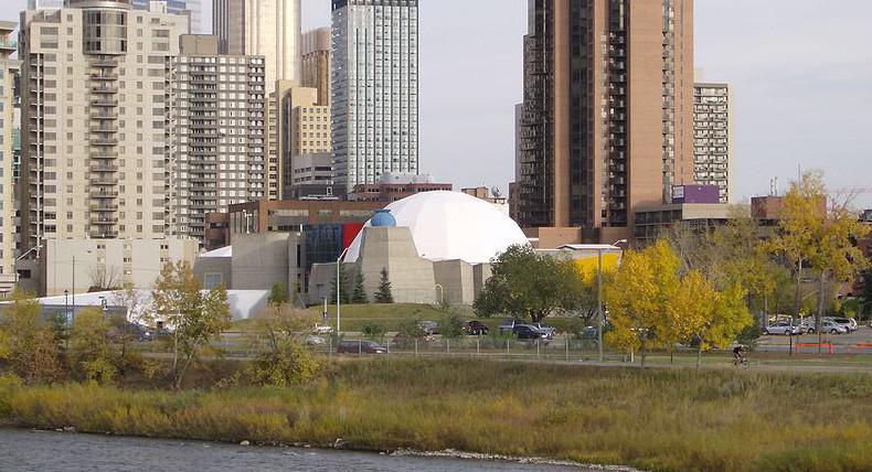 An image of old Calgary planetarium (with domed roof) at the edge of both west downtown and the Bow River. Photo: Wikimedia Commons.