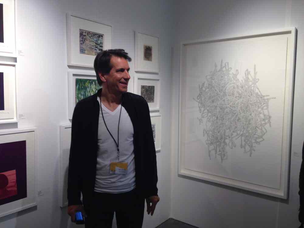 François Babineau of Montreal's Galerie Simon Blais in GSB's Papier14 booth—at right is a large drawing by Julie Ouellet.