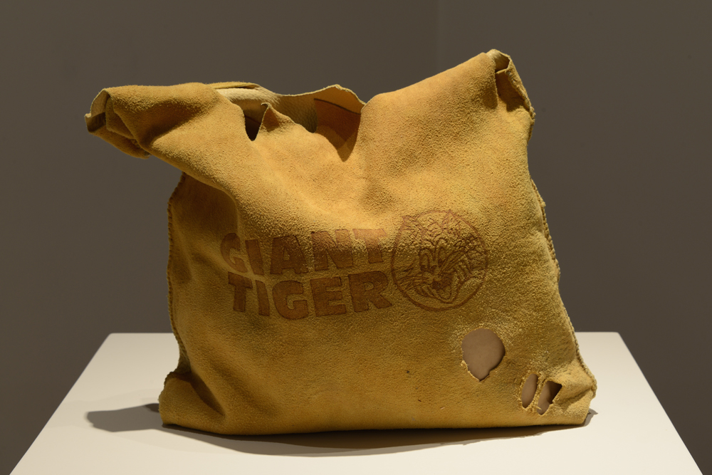 Jordan Bennett, a Newfoundland-born artist known for melding contemporary consumer culture with First Nations traditional materials, is one of the 25 artists longlisted for the 2016 Sobey Art Award. Here, his <em>Artifact Bags (Giant Tiger)</em> (2013) as seen at the Mendel Art Gallery. Photo: Tony Mamer.