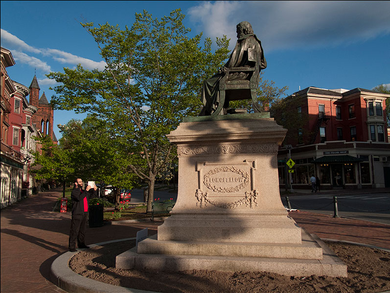 Mathieu Leger with Longfellow statue in Portland, Maine.