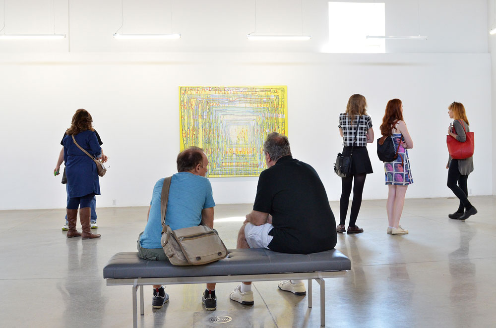 Visitors discuss Graeme Gillmore's exhibition at Division Gallery in Toronto during Gallery Hop 2014. 