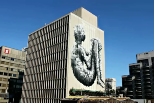 Watch UK Street Artist Phlegm Create an 8-Storey Mural in Toronto