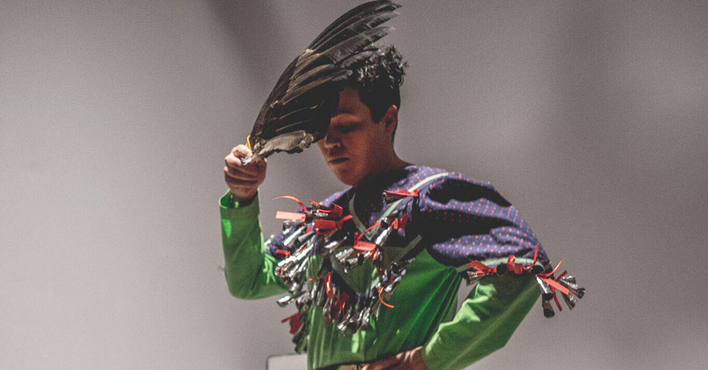 Raven Davis performs at their show "It's Not Your Fault" at the Khyber Centre for the Arts in Halifax in 2016. The exhibition responded to public acts of violence towards Indigenous women and culture in online comment sections. Photo: Samson Learn.