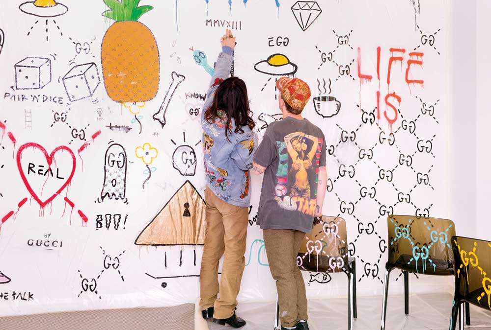 Gucci creative director Alessandro Michele and graffiti artist Trevor Andrew discuss designs from the GucciGhost collection.  Courtesy Gucci. Photo: Kevin Tachman.