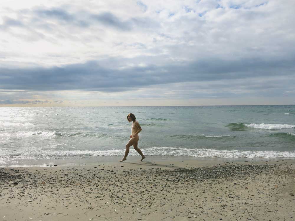Amelia Ehrhardt’s <i> solo dance to nobody documented in 
still image only #2 (from the series solo dances to nobody documented in still images only) </i>
at Gibraltar Point Beach, Toronto, October 2016