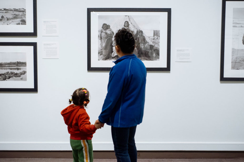 Visitors during Community Day at the Glenbow Museum consider the exhibition “North of Ordinary.” Photo: Elyse Bouvier.