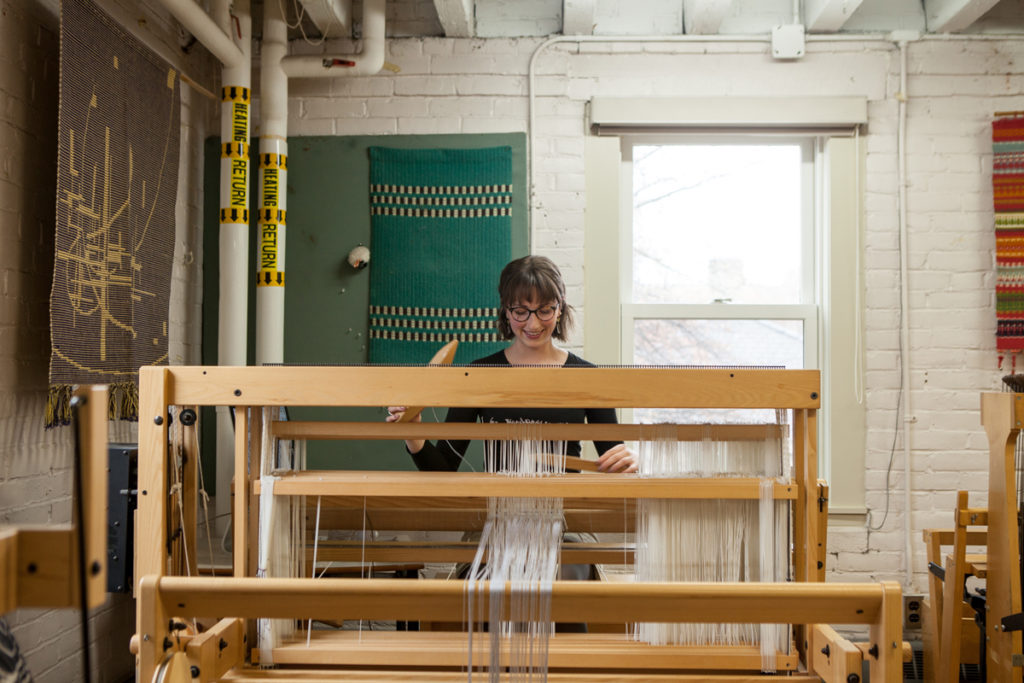 Weaver Emily Blair at work on a loom in the textile studios of the New Brunswick College of Craft and Design. Photo: NBCCD.