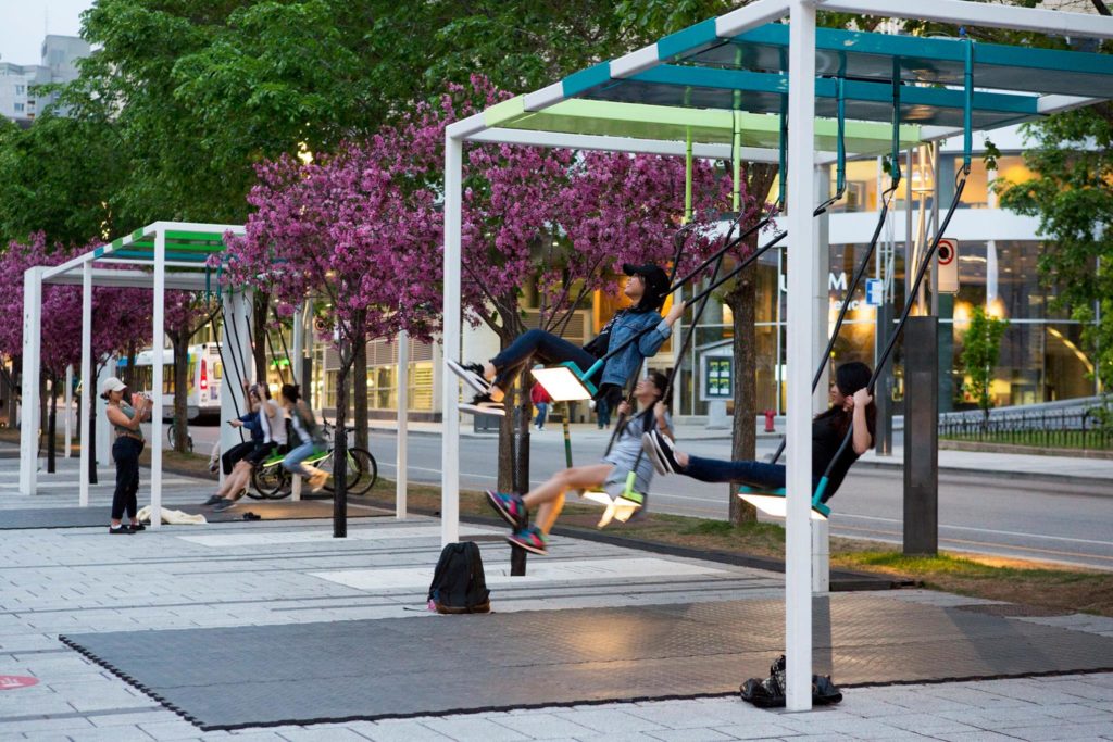 Public art, like <em>21 Balançoires</em> at Place des Arts in Montreal, is one part of the wide-ranging culture industries. In this extremely popular piece created by Montreal design studio Daily Tous Les Jours, users create music collaboratively by swinging. Photo: Martine Doyon via Place des Arts Facebook page.