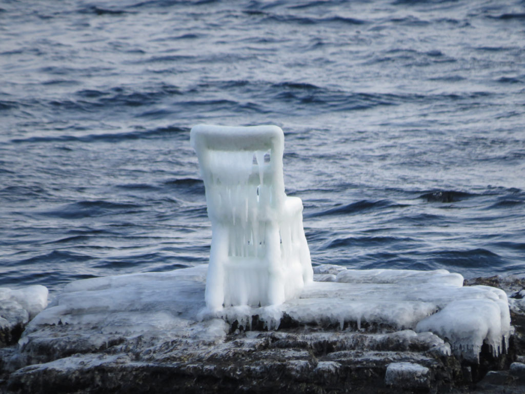Will Gill’s <em>The Green Chair</em> covered in ice on February 11, 2018. Courtesy www.townofelliston.ca. Photo: Neal Tucker.
