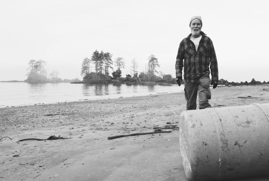 Douglas Coupland in Haida Gwaii with plastic barrel. Photo: JL Gijssen. 
