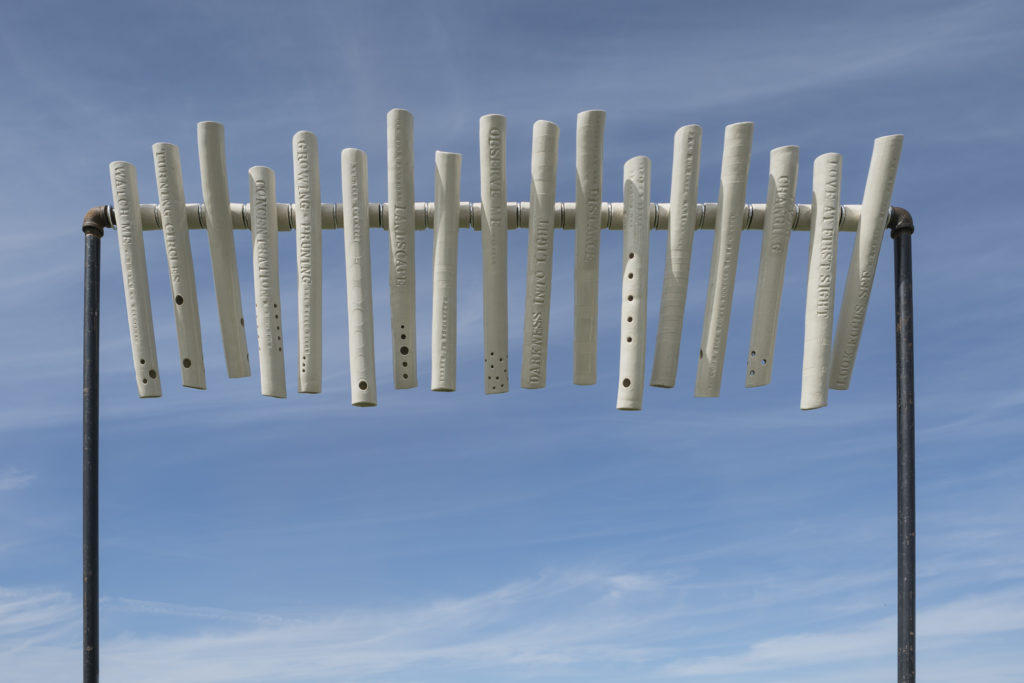 Installed in a Nova Scotia vineyard, Marla Benton’s <em>Tunnel Vision</em> invites viewers to swivel and peer through text-embellished clay tubes. The tubes also produce sound when the wind is blowing hard enough. Photo: Ernest Cadegan.