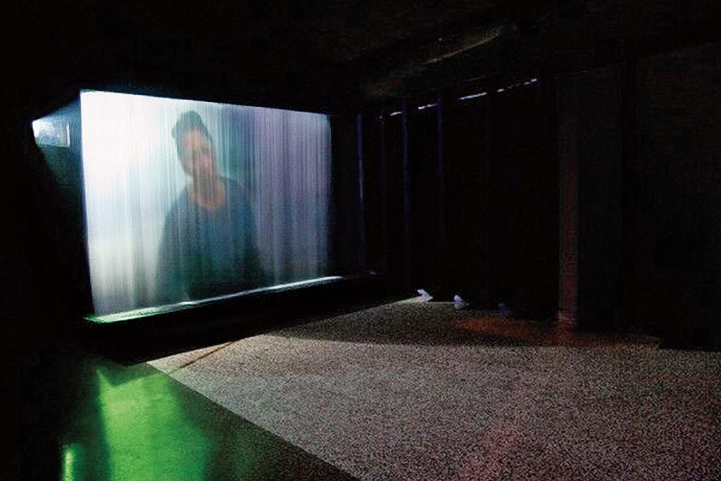 Rebecca Belmore, <em>Fountain</em>, 2005. Single-channel video with sound projected onto falling water, 274 cm x 488 cm. Courtesy of the artist. © Rebecca Belmore.