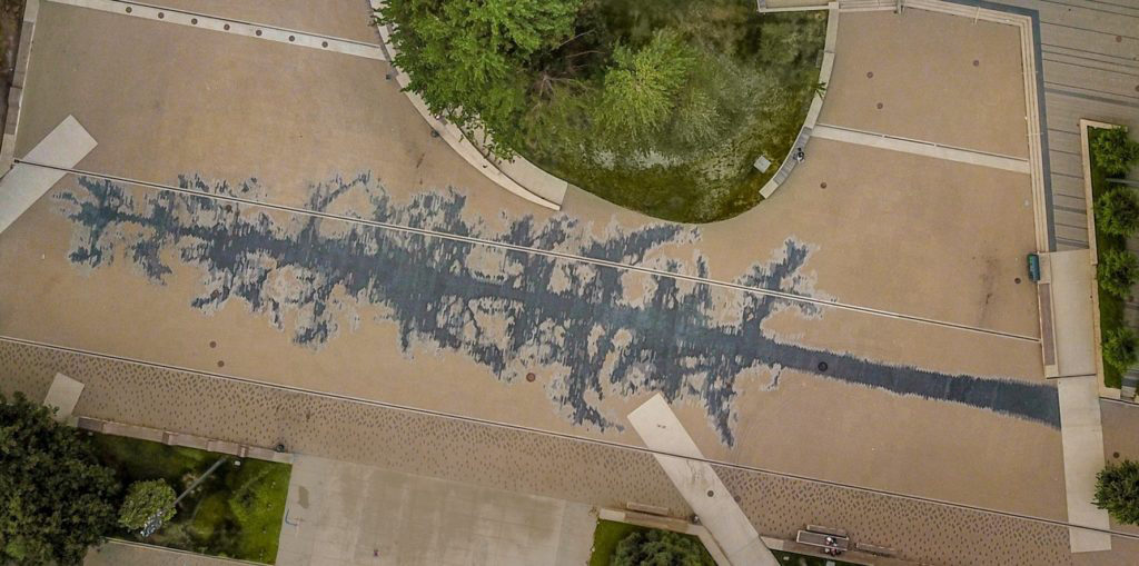 An aerial view of Ester Shalev-Gerz's new public artwork <em>The Shadow</em> at UBC in Vancouver. The work is created with differently coloured paving stones, and is only visible in total from above. Photo: Hassan El-Sherbiny via Facebook.