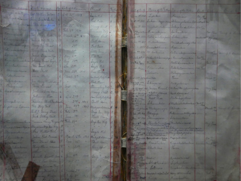 A copy of a residential school ledger book is on view at the new exhibit. The book tracked when students were born, where they were from, and when they were discharged—or often, died at school. Photo: Tanya Harnett.
