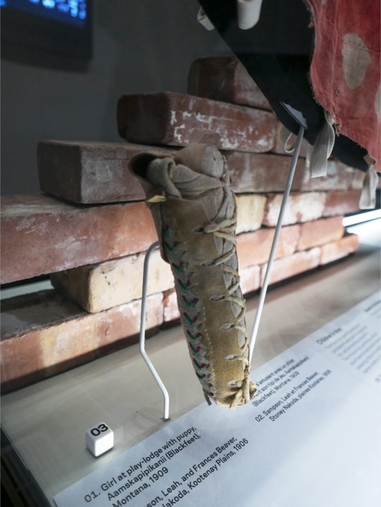 A moss bag baby doll, as well as bricks from St. Paul's Residential School, are part of the new residential schools exhibit at the Royal Alberta Museum. Photo: Tanya Harnett.