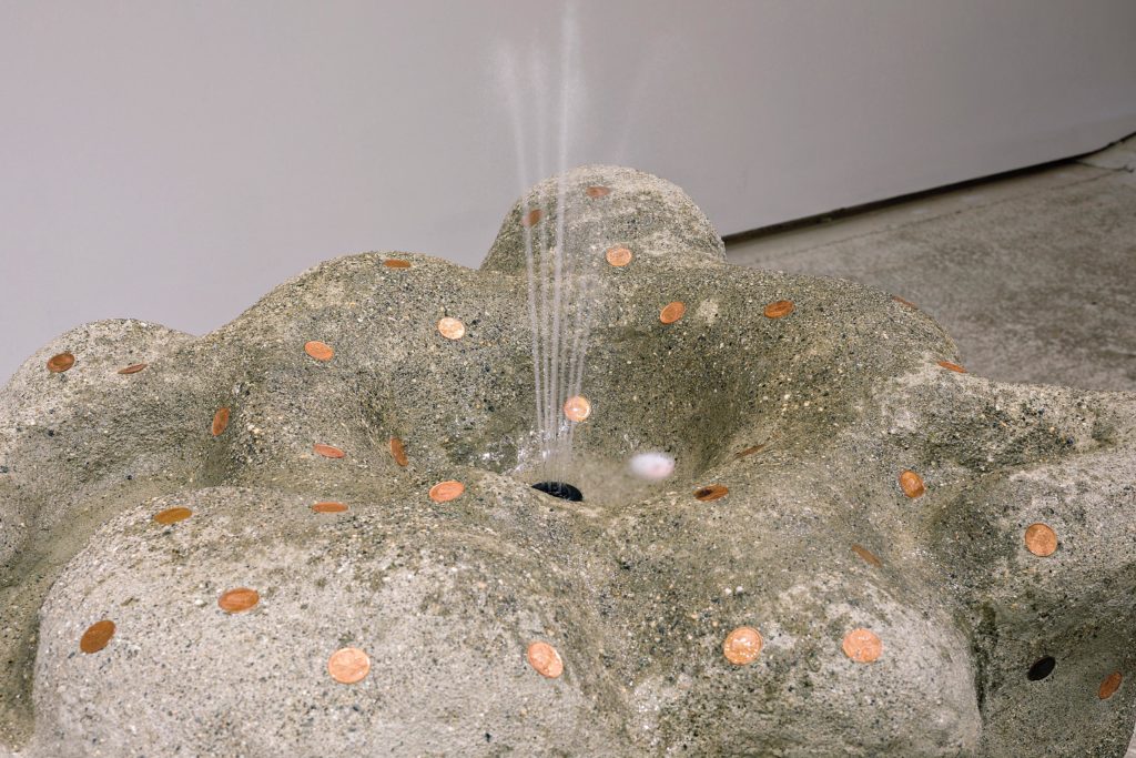 Alex Tedlie-Stursberg, <em>Warped Fountain</em> (detail), 2018. Cement, sand, pennies, water, fountain pump, fibreglass, polystyrene and fake plant, 2.08 m x 68.6 cm x
71.1 cm. Courtesy Burrard Arts Foundation. Photo: Dennis Ha.