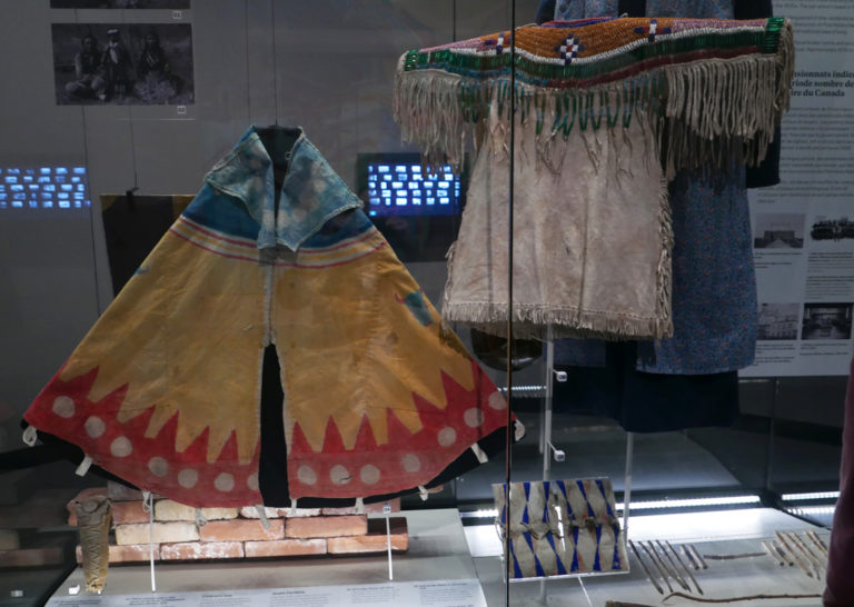 A small, child-size tipi and a Blackfoot girl’s dress—as well as screens with archival photos of residential school students—are part of the new exhibit on residential schools at the Royal Alberta Museum. Part of the intent was to educate the thousands of youth visitors that the museum gets every year. Photo: Tanya Harnett.