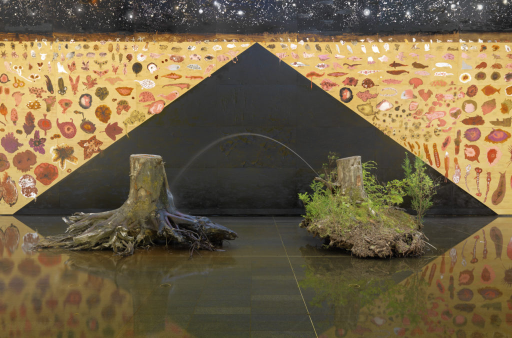 Marina Roy, <em>Your Kingdom to Command</em>, 2016. Mural with latex paint, bitumen, red-iron oxide, shellac and tar on plywood, with tree stumps and fountain.  2.56 x 6.09 metres overall. Courtesy the artist/Vancouver Art Gallery.