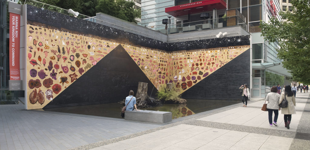 Marina Roy, <em>Your Kingdom to Command</em>, 2016. Installation at Offsite, Vancouver Art Gallery, June 2 to October 10, 2016. Mural of latex paint, bitumen, red-iron oxide, shellac, and tar on plywood; also stumps/fountain;  84 × 20 × 20 feet. Courtesy the artist.
