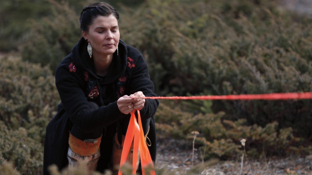 Meagan Musseau, <em>when they poison the bogs we will still braid sweetgrass</em>, 2017. Digital video still from a land-based performance on Treaty 7 Territory, 10 minutes, 42 seconds. Courtesy the artist.