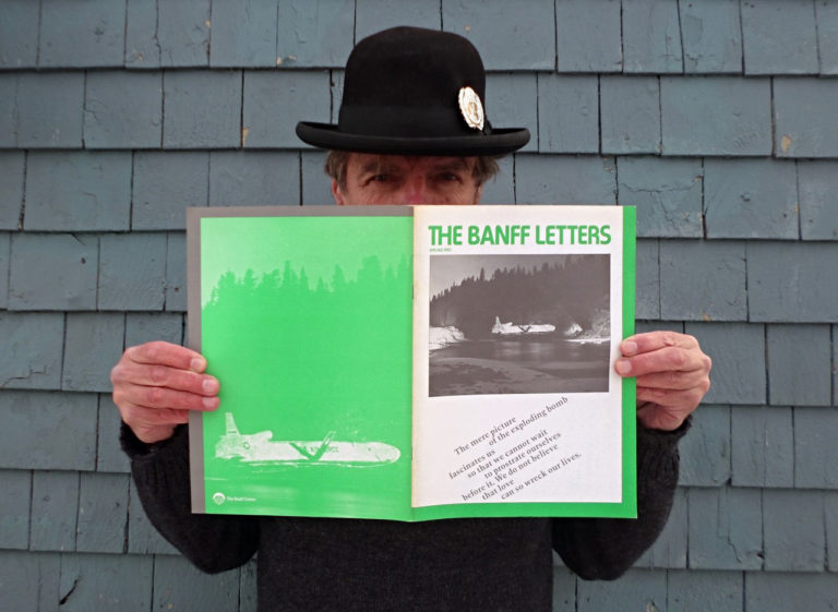 Artist Brian MacNevin holds a document related to a public Krzysztof Wodiczko projection he assisted with at Walter Phillips Gallery in Banff in 1983. Photo: Wanda Kushner. 