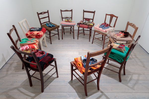 Charlene Vickers, <em>Sleep Walking</em>, 2016. Twelve 1920s bedroom chairs, beer case cardboard, denim, cotton, blankets, glass beads, letter beads and thread, dimensions variable.