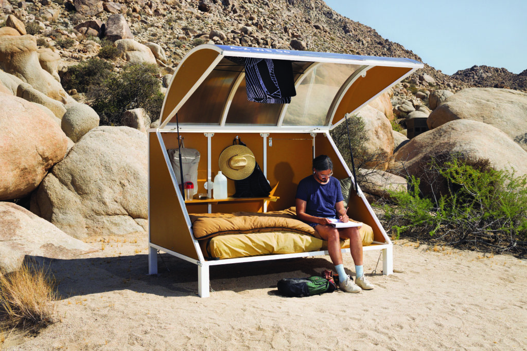 Andrea Zittel, <em>A-Z Wagon Stations: Second Generation</em>, 2012–. Powder-coated
steel, aluminum, plexiglass, wood, canvas, futon, pillow,
hand brush, straw hat,
2.08 x 5.86 x 1.44 m each. Courtesy Regen Projects, Los Angeles.
Photo: Lance Brewer.