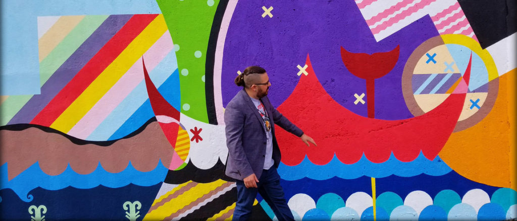 Artist Jordan Bennett in front of his mural on Queen’s Road in St. John’s, Newfoundland, as part of the Identify: A Celebration of Indigenous Arts and Culture Festival, held in April 2018. Bennett received his first Canada Council grant in 2009, early on in his career.