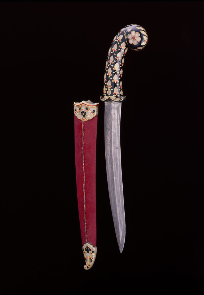 Dagger and Scabbard, probably Deccan, first half of 17th century. Hilt: Jade, inlaid with gold set with jade and rubies. Blade: Steel. Scabbard: Wood covered in fabric trimmed with metal thread. Locket and chape: Jade, inlaid with gold set with jade and rubies. © The al-Sabah Collection, Dar al-Athar al-Islamiyyah, Kuwait. Courtesy Aga Khan Museum.