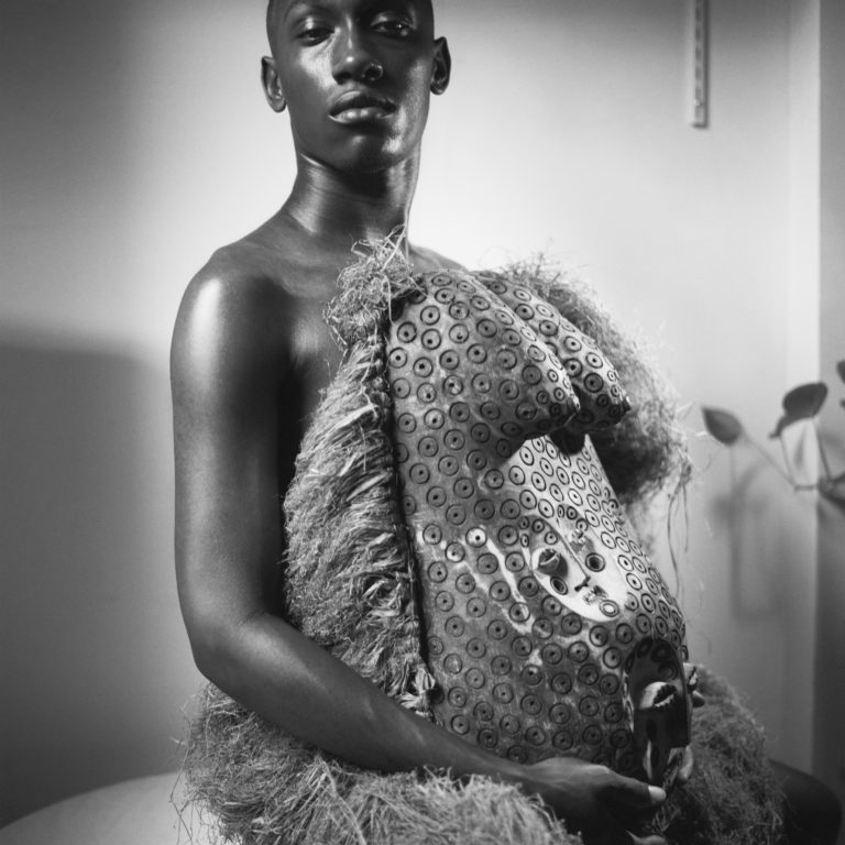 John Edmonds, <em>Young man wearing a maternity bust (from the Makonde tribe),</em> 2019. Digital silver gelatin photograph, 40 x 40 in. Courtesy the artist and Company, New York.