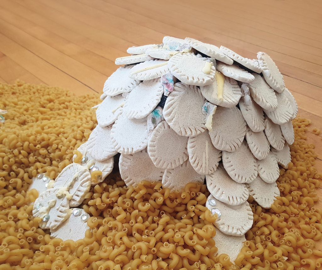 Zoë Schneider, <em>Fat Armour</em>, 2019. Foam, plaster, silicone, sand, glass, salt dough, pasta and found debris, dimensions variable.