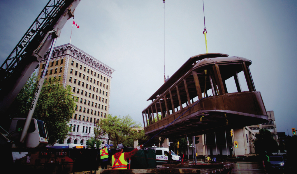 The new public artwork <em>Bloody Saturday</em> by Bernie Miller and Noam Gonick as it was being installed in Winnipeg. The artwork references a famous photograph of a tipped trolley during the 1919 General Strike. Photo: Courtesy Winnipeg Arts Council.