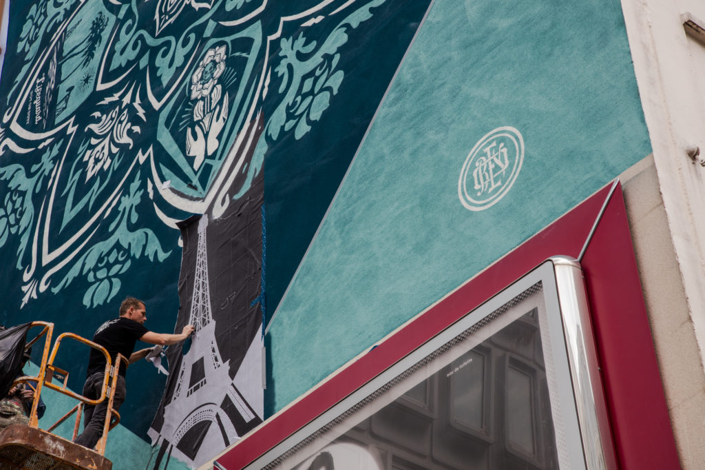 Shepard Fairey working on <em>Delicate Balance</em> in Paris in 2016.