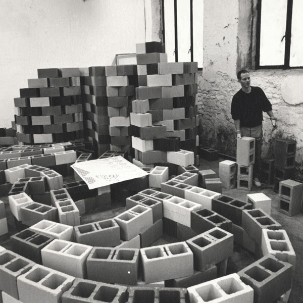 “Complex Milano installation” 1994.  Alan Belcher installing the bricks according to floorplan. Photograph by Armin Linke.