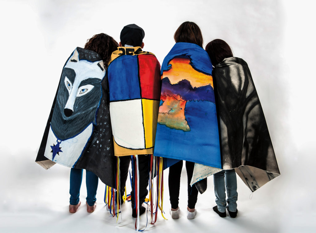 Faye HeavyShield (with youth from Moving
the Mountain program), <em>The Shawls Project</em>, 2016. Documentation of youth artists with shawls. Curated by Ociciwan
Contemporary Art Collective. Photo: Eric Kozakiewicz.