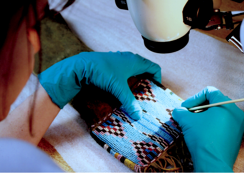 A student in the Fleming College Cultural Heritage Conservation Management program attends to beadwork conservation. Photo: Fleming College.
