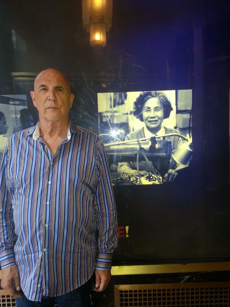 Bruce Ferguson in front of a photo of Ken Lum's grandmother at the Unite Here! headquarters in New York, 2013. Photo: Ken Lum.