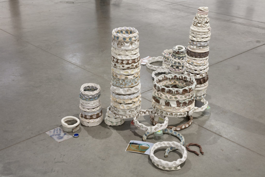 Marlon Kroll, <em>Olympic Rings / Holding Hands</em>, 2019. Glazed ceramics, coins, bottle caps, glasses with evaporated tums, dimensions variable. Courtesy the artist/Parisian Laundry. Photo: Maxime Brouillet.