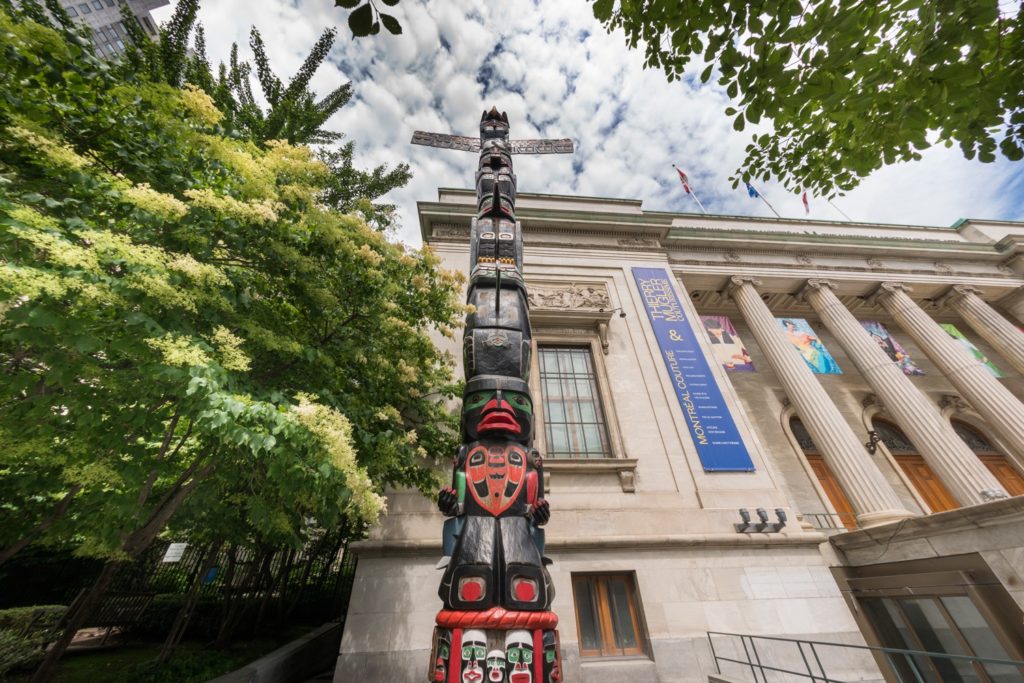 Charles Joseph's Residential School Totem Pole has been installed outside the Montreal Museum of Fine Arts for two years or so. Recently, a lower portion of the pole was removed by vandals. Vandals later returned the missing piece with an apology. Photo: Facebook / Montreal Museum of Fine Arts.