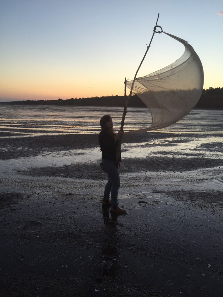 Lindsay Dobbin performing <i>Drumming the Tide/Body Sail</i> on the Bay of Fundy, NS, in 2015. Photo: Rob Cameron.