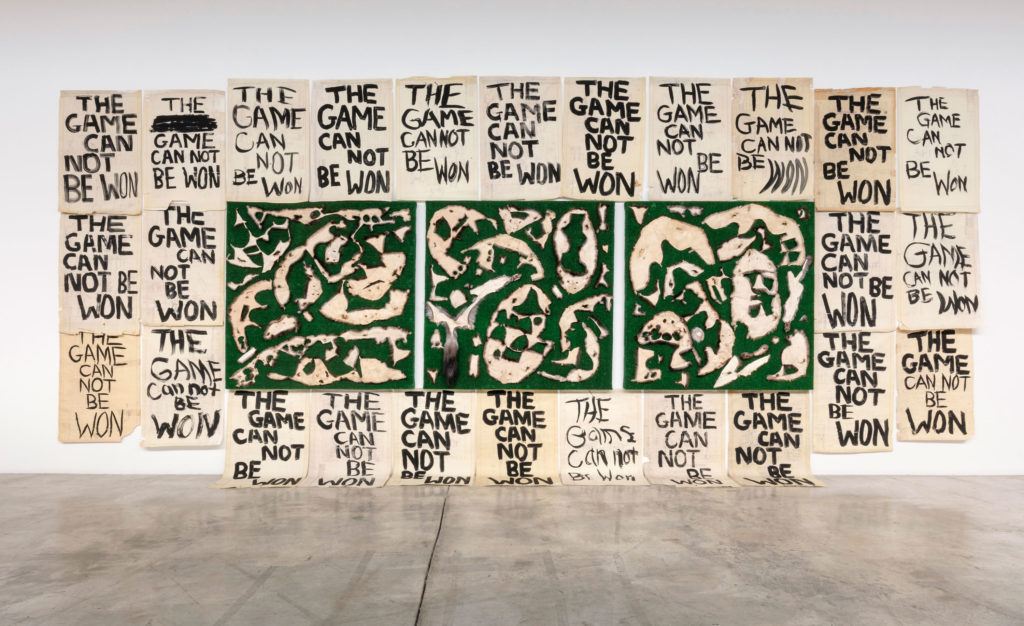 Joseph Tisiga, installation view of <em>An Exercise in Resilience 1, 2, and 3</em>, 2016. Animal furs, artificial grass on plywood. And <em>The Game is Not a Game</em>, 2016. Mixed media on diazotype. Courtesy Diaz Contemporary and National Gallery of Canada. Photo: Toni Hafkenscheid. © Joseph Tisiga.