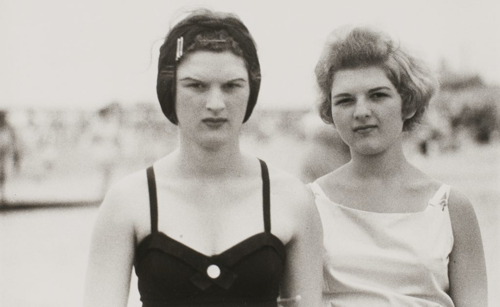 Diane Arbus, <em>Two girls on the beach, Coney Island, N.Y., 1958</em>, 1958. Gelatin silver print; printed later. Sheet: 27.9 × 35.6 cm. Gift of Robin and David Young, 2016. Courtesy Art Gallery of Ontario. Copyright © Estate of Diane Arbus 2016/956.