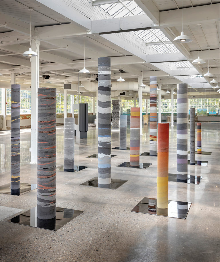 New Mineral Collective, <em>Pleasure Prospects</em>, 2019. Columns, casts of prospecting boreholes, rammed earth, hand-pulverized black copper slag, copper, zinc, steel, aluminum, fine gold and silver shavings and concrete, dimensions variable. Courtesy Toronto Biennial of Art. Photo: Toni Hafkenscheid.